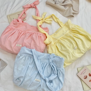 Detailed flat lay of three macaron-colored canvas tote bags with pleated knots and bows