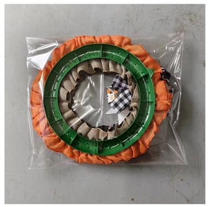 Detail of Halloween ghost wreath featuring orange burlap and black-white checkered ribbons
