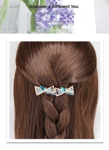 Detail shot of a women's rose gold hair clip featuring colorful inlaid rhinestones