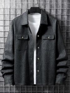 Macro detail of the dense wool blend texture and metal snap buttons on this dark grey shacket