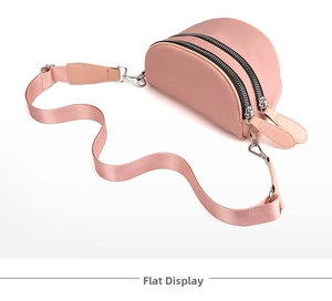 Close-up of pink nylon crossbody dumpling bag featuring dual zippers and adjustable strap