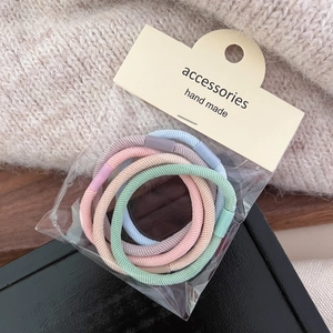 Set of five pastel elastic hair ties in pink, blue, green, beige, and purple colors