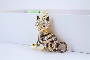 Detailed view of lucky cat keychain featuring sparkling crystals and gold stripes