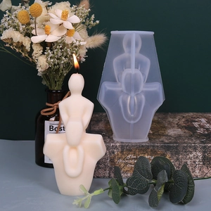 DIY human figure silicone mold for candles and plaster art with a burning candle