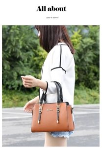 Detail of a brown lychee pattern tote bag with black handles in bright natural light
