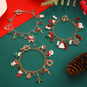 Christmas charm bracelet with Santa Claus and snowflake pendants on festive background