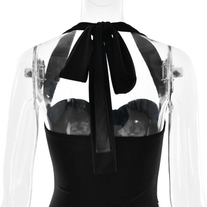 Detail showing backless halter neck design with tie-up bow on black midi dress