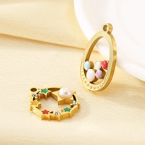 Detail view of 18K gold star and oval charms with colored beads and pearls
