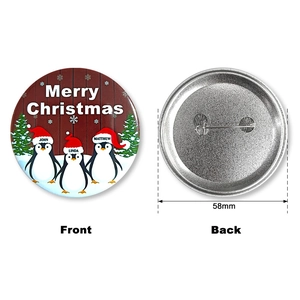 Detailed front and back view of 58mm Christmas penguin button badge with safety pin