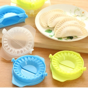 Juego de moldes manuales para empanadillas de plástico de colores sobre madera