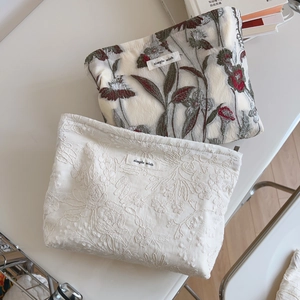 Detail of floral embroidery and leaf print on cotton fabric bags with simple wish label