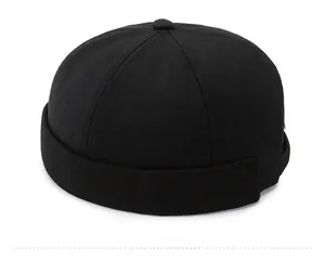 Detail view of the red steering wheel embroidery on the black cotton docker cap