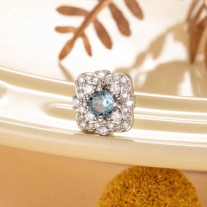Vintage flower-shaped cubic zirconia stud earring with blue center stone and silver steel