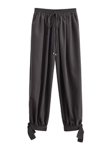 Close-up of drawstring elastic waist and bow-knot detail on casual lantern trousers