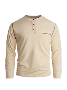Detail of men's beige Henley shirt featuring three-button collar and chest pocket stitching