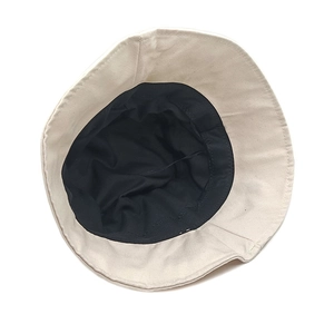 Detail view of double-layer beige cotton fisherman hat with black sunproof lining
