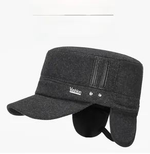 Close-up of wool texture and V-logo on gray winter flat-top cap with ear flaps