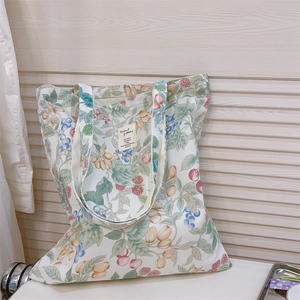 Floral canvas tote bag with cherry prints and woven label for a natural summer aesthetic