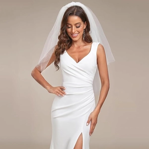 Elegant white sleeveless V-neck wedding dress with ruching detail and high side slit
