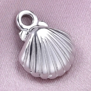 Macro shot of silver 304 stainless steel shell pendant showing detailed metal textures