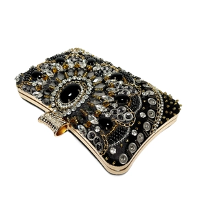 Detailed view of luxury evening clutch featuring intricate crystal beading and gold metal frame