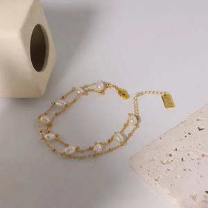 Elegant double-layer golden bracelet with natural pearls and adjustable lobster clasp