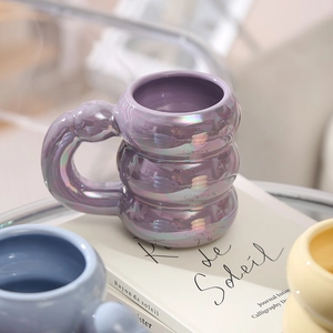 Unique purple stackable ceramic mug with a smooth glazed finish and rounded handle