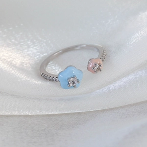 Detailed macro of flower ring with pastel enamel, tiny zircon stones and adjustable band