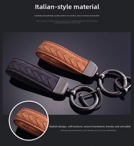 Detail of woven suede leather keychain with gunmetal buckle on reflective background