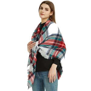 Detail shot of soft cashmere-feel scarf featuring classic plaid pattern and fringe edge