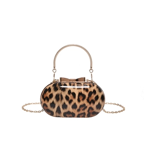 Elegant leopard print hard shell handbag with metal handle and golden bow clasp