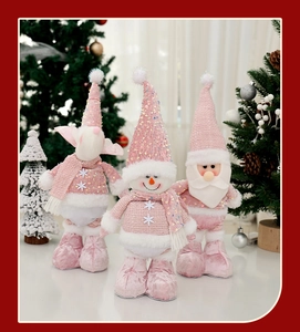Detailed view of pink sequined Christmas plush figurines with knit fabric textures