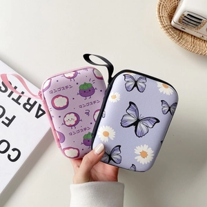 Detailed view of portable EVA fruit-themed storage cases for earphones and chargers