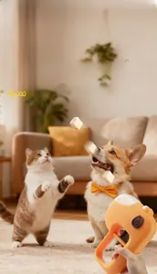 Pet snack launcher toy showing a Corgi and cat jumping for treats in a living room