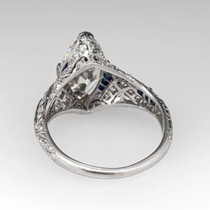 Detailed macro view of an Art Deco ring featuring a large marquise diamond and blue sapphires