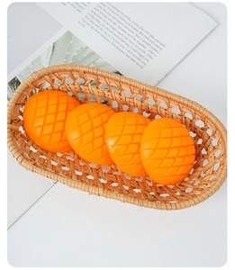 Realistic artificial mango cubes with cross-cut texture in a woven basket for decor