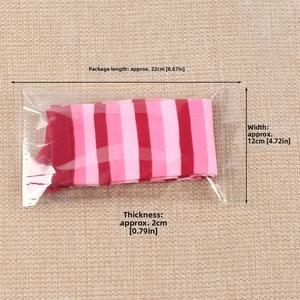 Detail showing red and pink striped knee high socks in flat transparent packaging