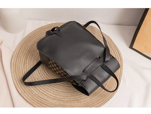 Detail of a casual mini backpack with brown pattern sides on a round straw mat base