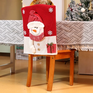 Detail of Christmas snowman chair cover with 3D elements on a wooden dining chair