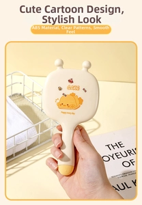 Detailed view of handheld cartoon massage hairbrush with cute duck print and ABS material