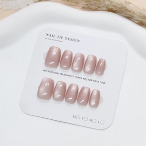 Handmade cat-eye press-on nails in sweet dusty pink on a professional display card