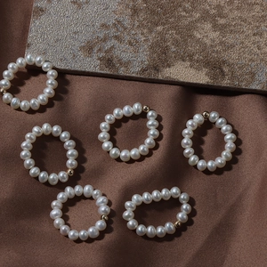 Elastic natural freshwater pearl rings with 14K gold filled beads on silk background