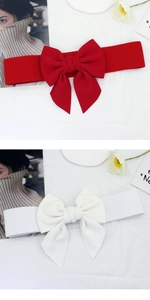 Detail of red and white elastic waist belts featuring a large decorative 3D cotton bow
