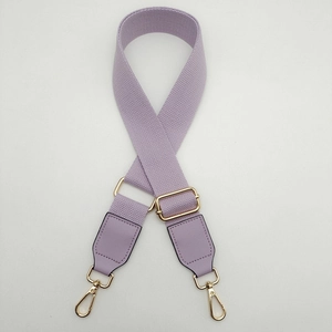 Detail of purple canvas strap with adjustable gold buckle and premium leather ends