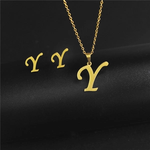 Detailed view of polished stainless steel letter Y pendant necklace and stud earrings set