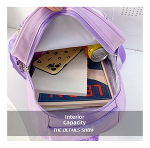 Detailed view of the purple kids backpack internal storage showing items for school