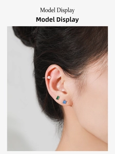 Close-up of S925 silver stud earring set with pearl, green and blue gemstones on ear