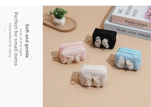 Corduroy coin purses with pearl lace bows and gold keychains in four pastel colors