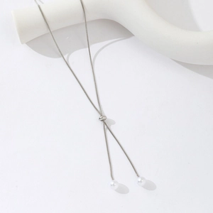 Detail of adjustable silver snake chain with two white pearls and a sliding adjuster