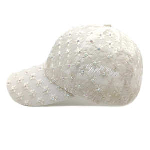 Close-up of white lace mesh baseball cap with 3D daisy flower embroidery and sequins